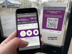 Image of mobile phone scanning QR code at bus stop